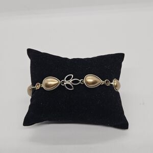 gold tone teardrop link bracelet with orangey rhinestones